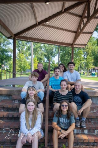 Extended Family on the Pavilion Steps Extended family seated together on the brick steps of a park pavilion on a summer afternoon