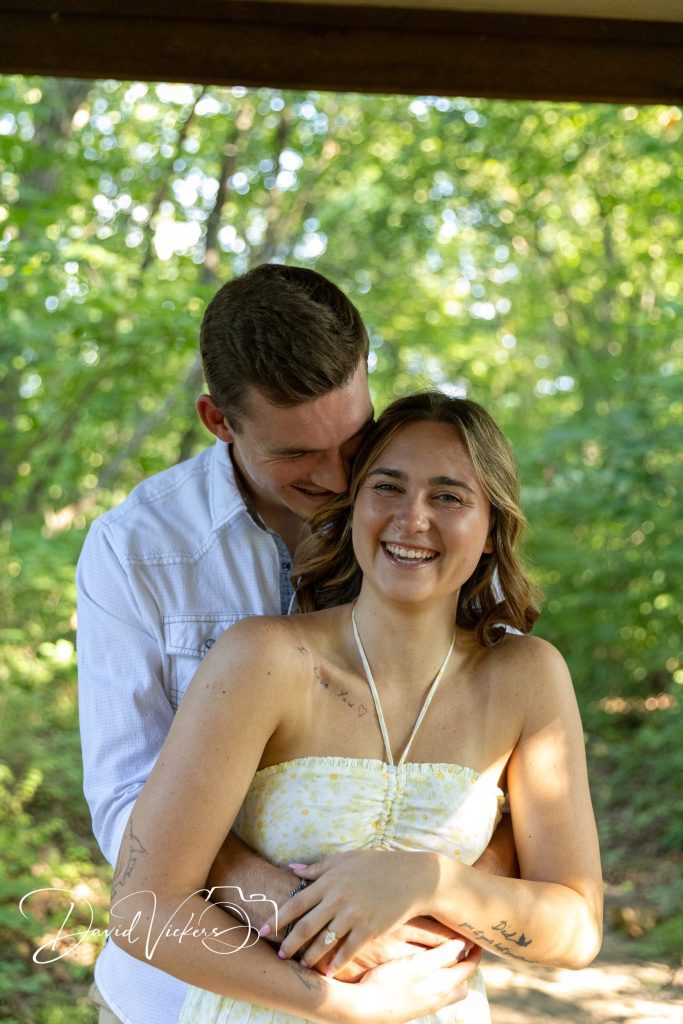 Engagement Photography Engaged couple laughing together under trees during a Kansas City engagement photography session