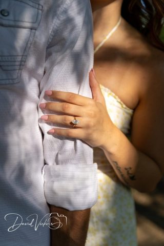 1g2a4923 Close-up of an engagement ring as the bride-to-be rests her hand on her fiance's arm