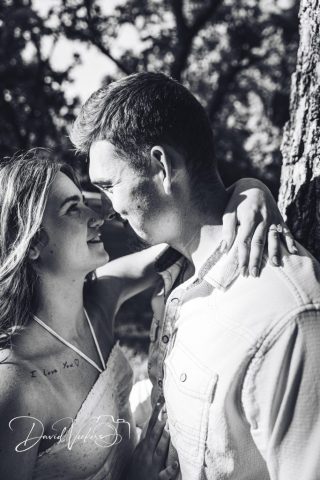 1g2a5085 Black and white photo of an engaged couple leaning in close, her arm around his shoulder