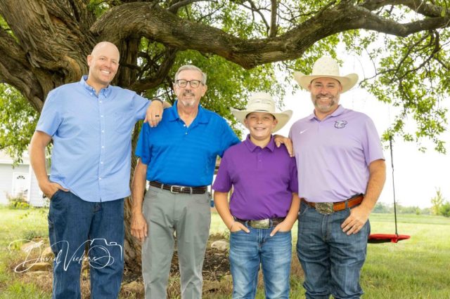Grandfather, sons and grandson under a tree in Kansas Grandfather, sons and grandson under a tree in Kansas