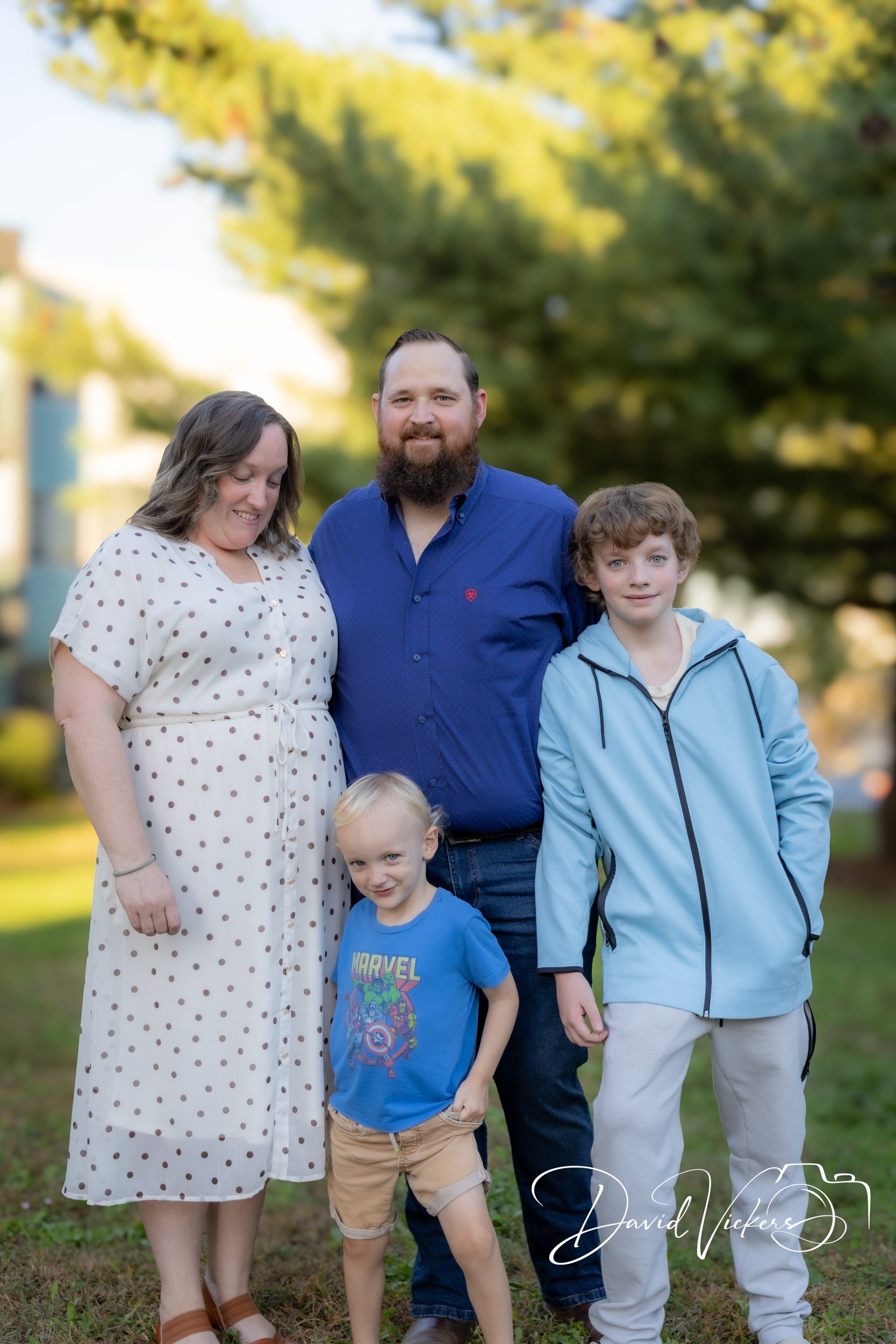 Lifestyle Family Photography in Kansas City: What to Expect The same family a few frames later, relaxed and leaning in, with the youngest playfully mid-motion